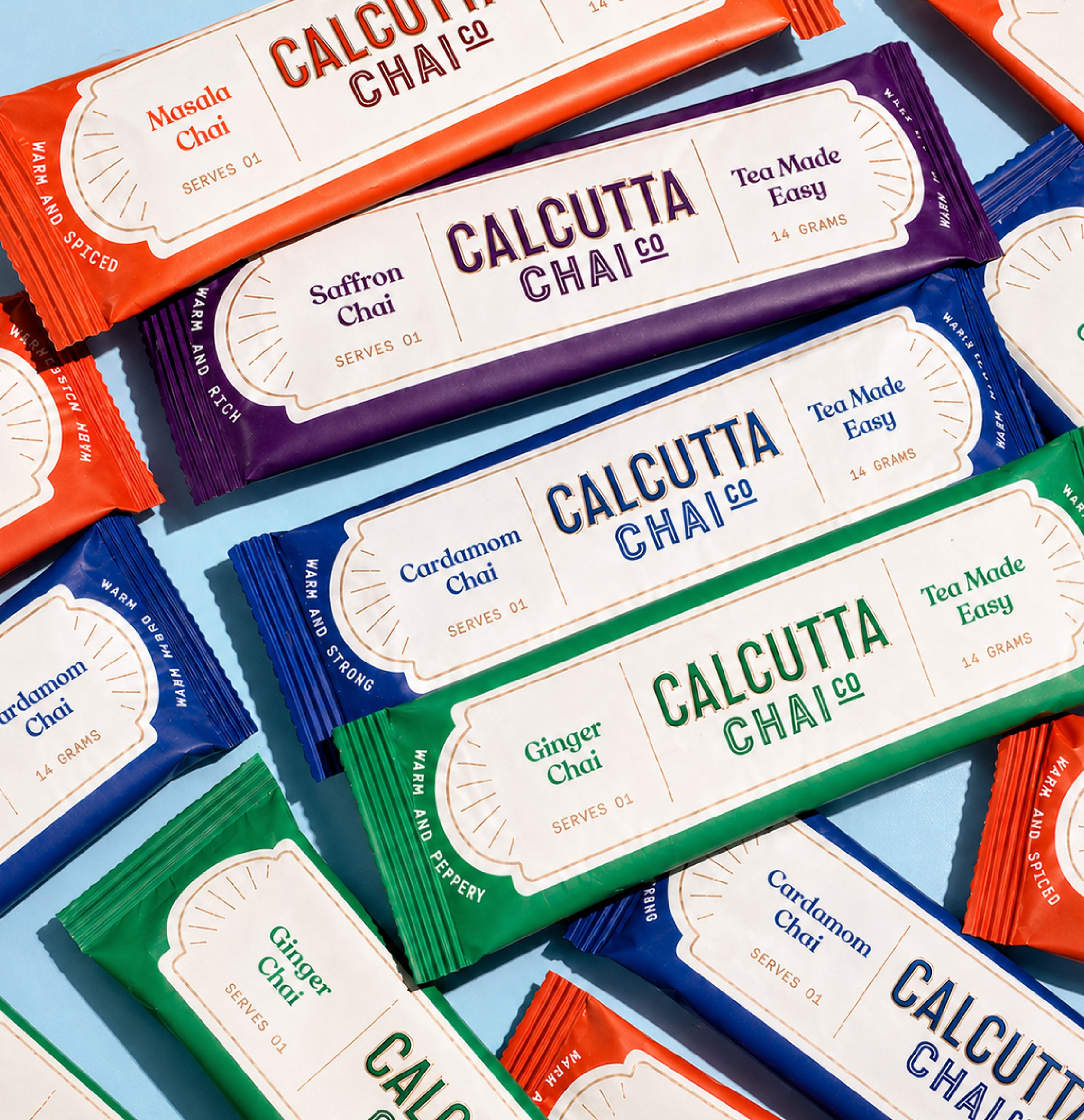 Close-up of colorful packaged tea chai products labeled as Calcutta Chai with flavors including Masala, Saffron, and Ginger.