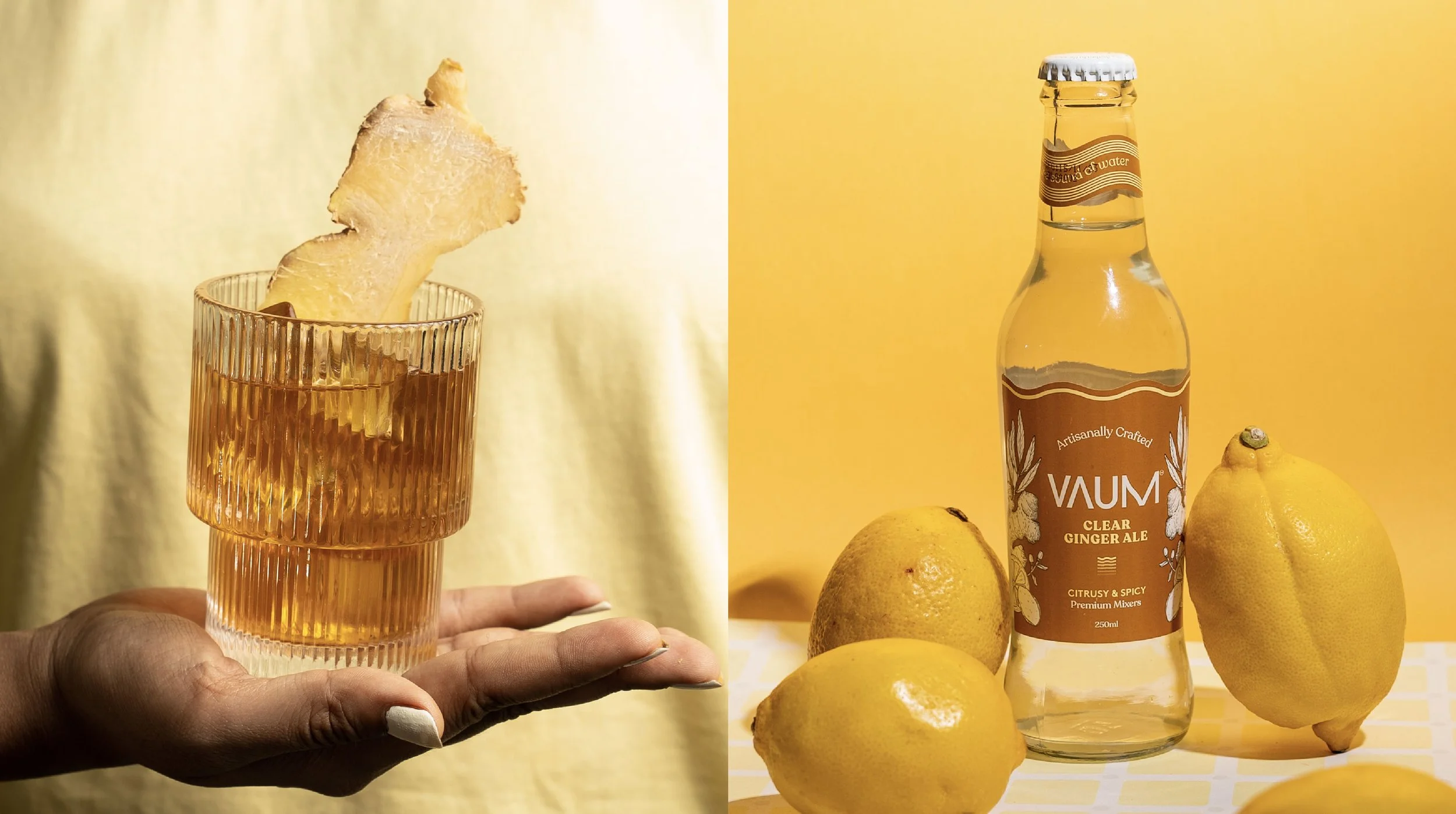 Side view of a glass with an amber-colored beverage and a ginger slice garnish, held by a hand with painted nails, against a yellow background; on the right, a bottle labeled 'VAUM' Ginger Ale with lemons surrounding it, also against a yellow backdro