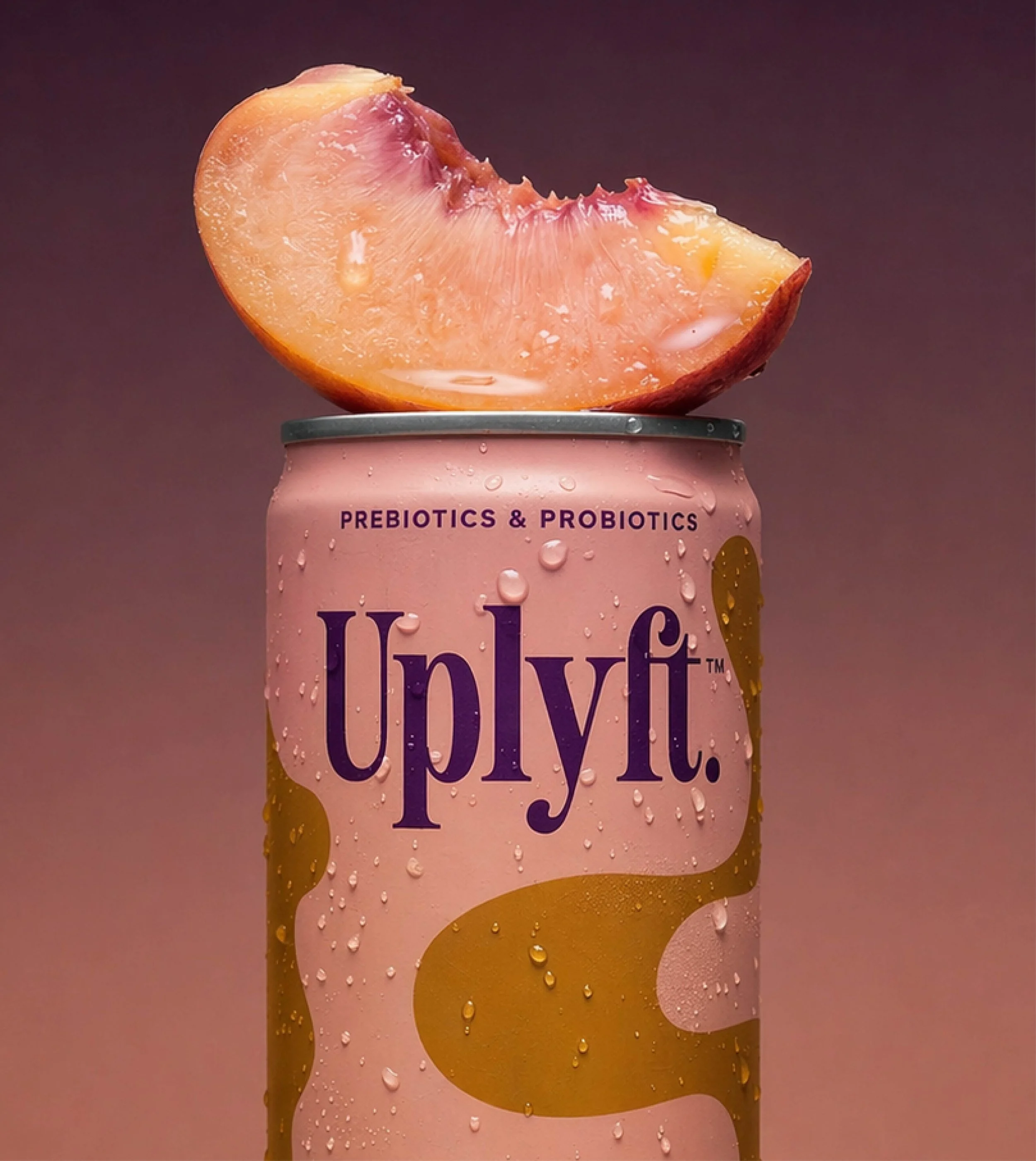 Close-up of a peach-flavored beverage in a can, topped with a peach slice, with condensation droplets on the can, labeled as prebiotics and probiotics.