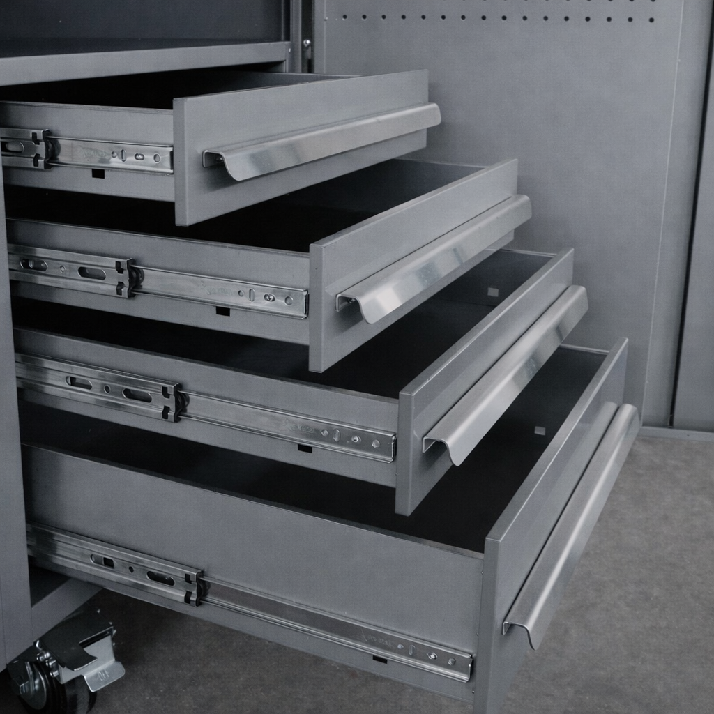 Empty gray metal filing cabinet with four open drawers.