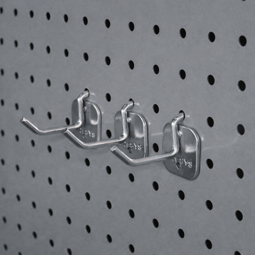 Close-up of three metal hooks mounted on a gray pegboard with evenly spaced holes.
