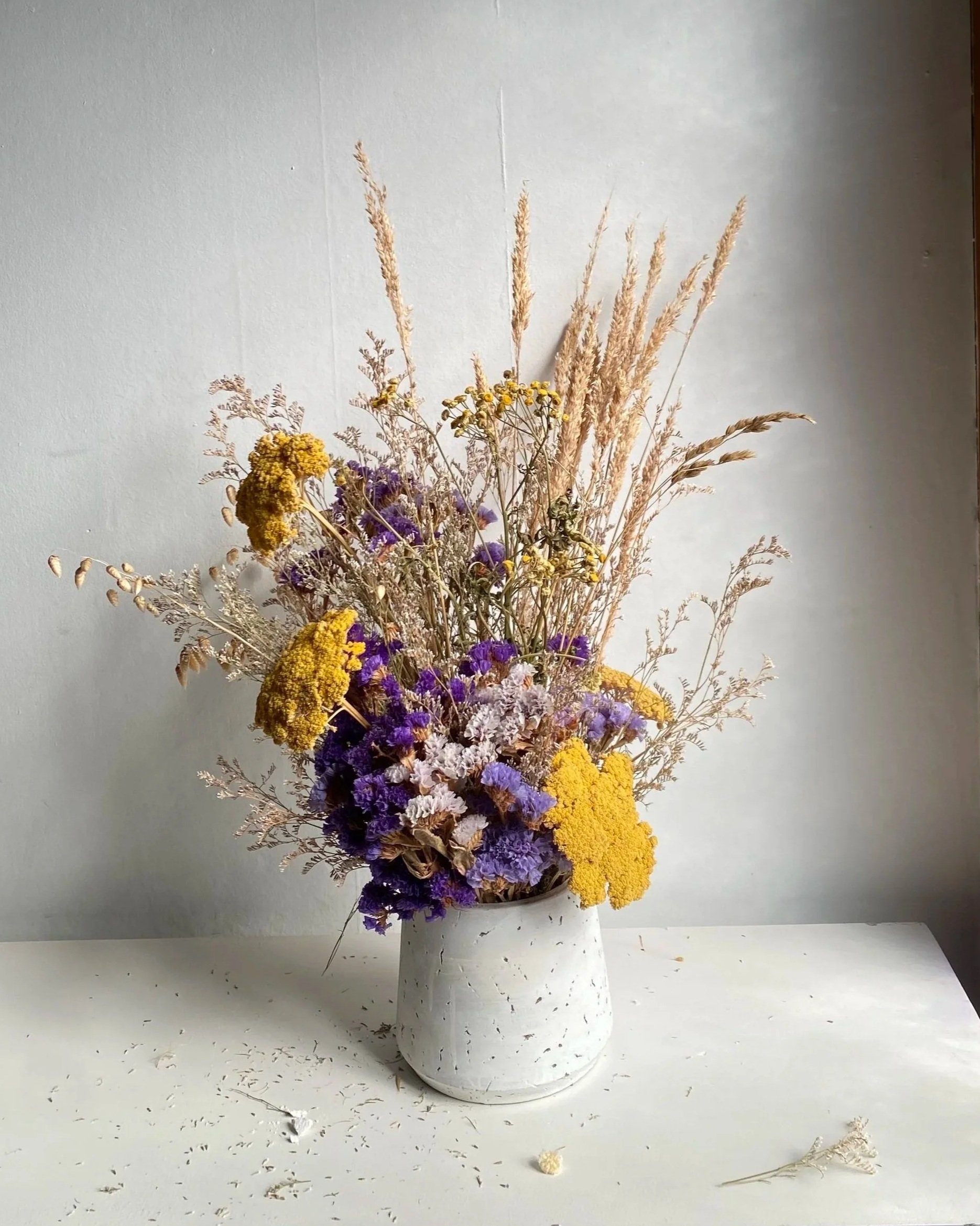 Violet + mustard in concrete vase