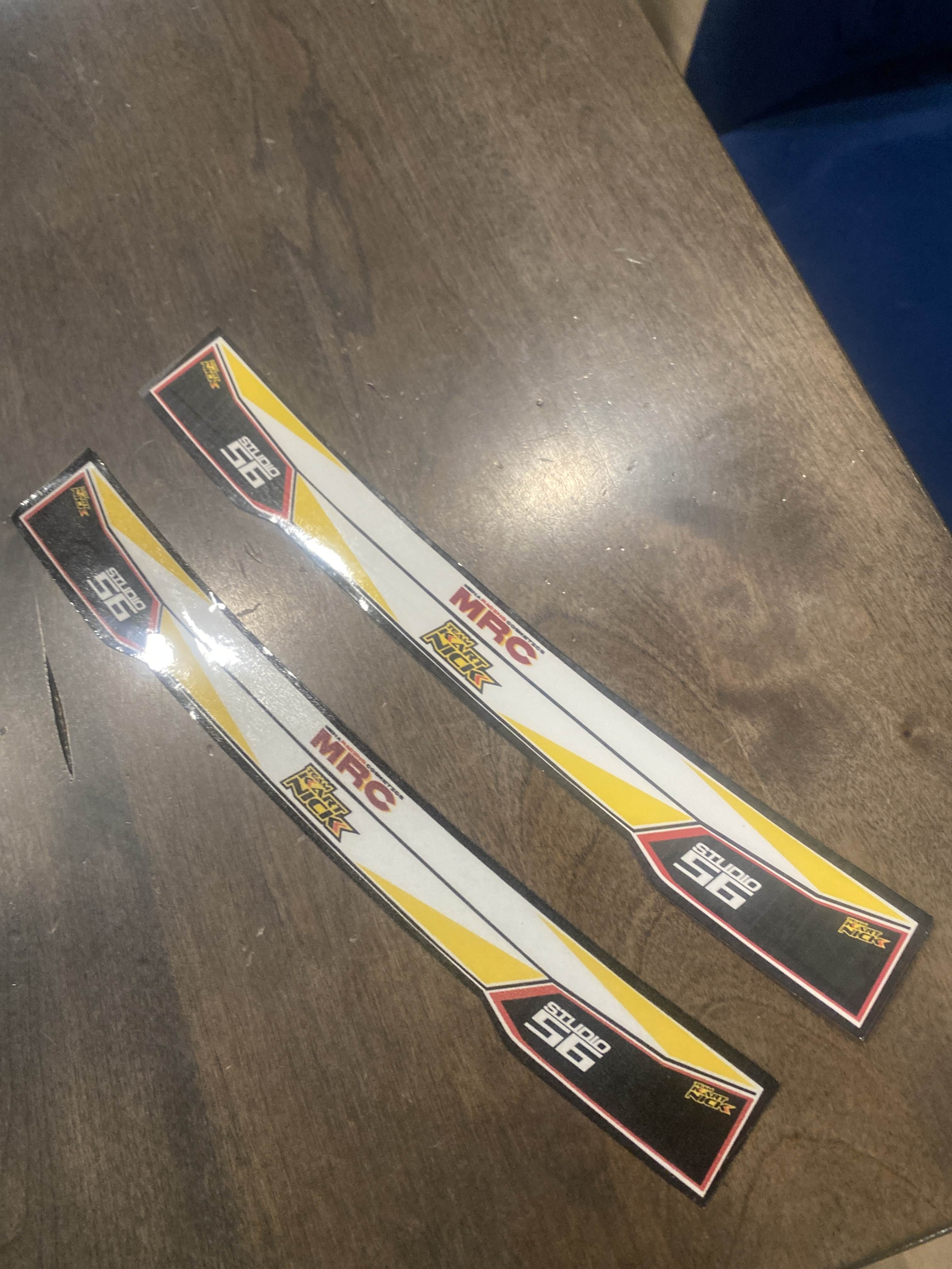 Two hockey stick blade wraps labeled 'STX Stealth' with 'MIRCO' branding, laying on a dark wooden surface.