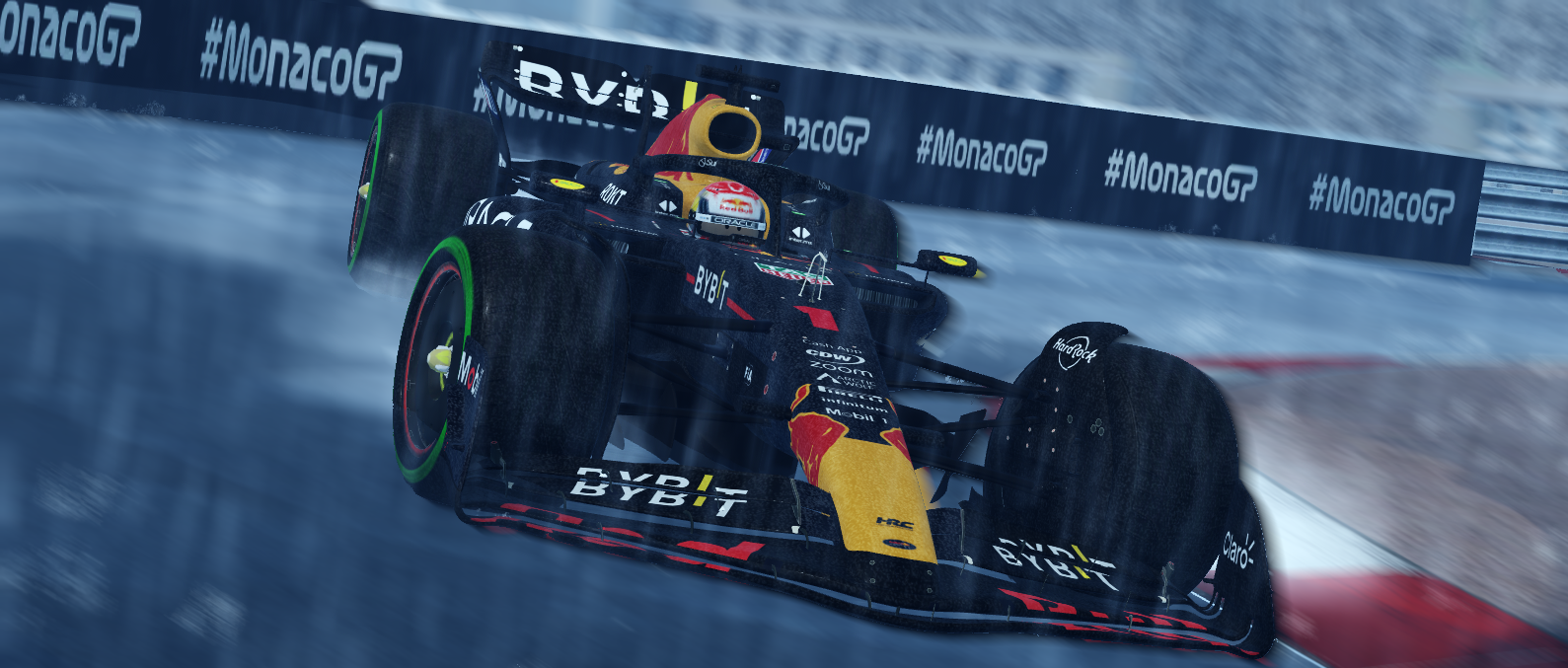 A race car speeding on a wet track during Monaco Grand Prix, with water spray behind the tires and barriers with #MonacoGP branding.