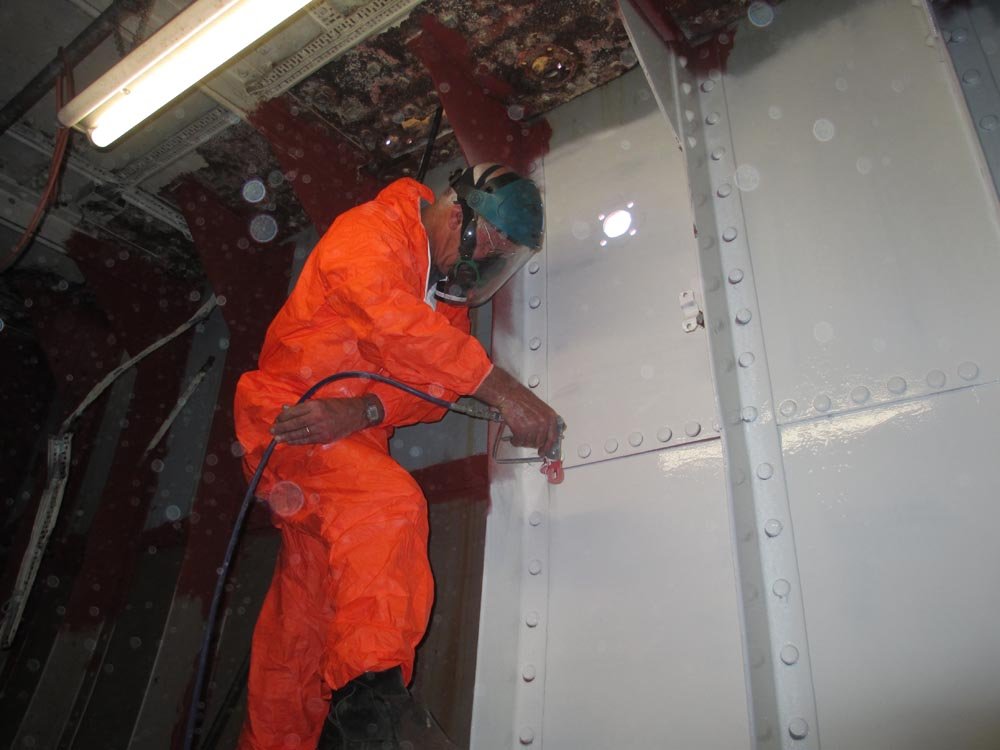 Ian-spray-painting-hull-inside-engine-room.jpg