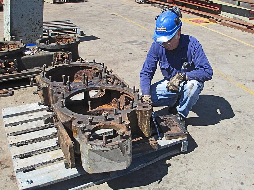 Owen-inspecting-dismantled-air-pump-base-ashore.jpg