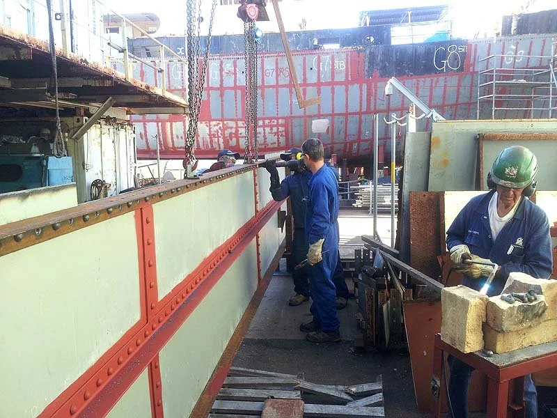 Team riveting forward part bridge deck