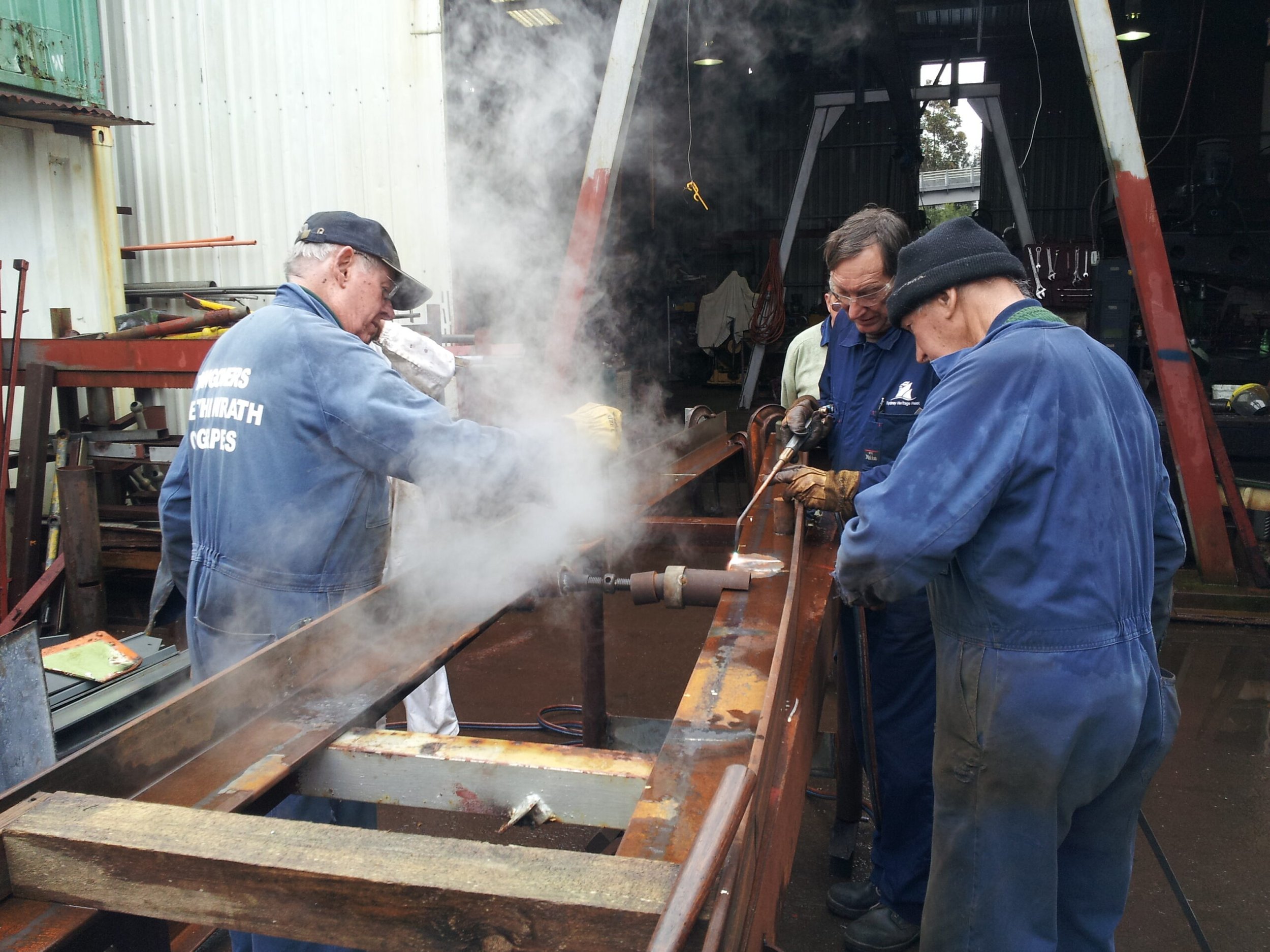 New main deck beams being shaped by torch and water