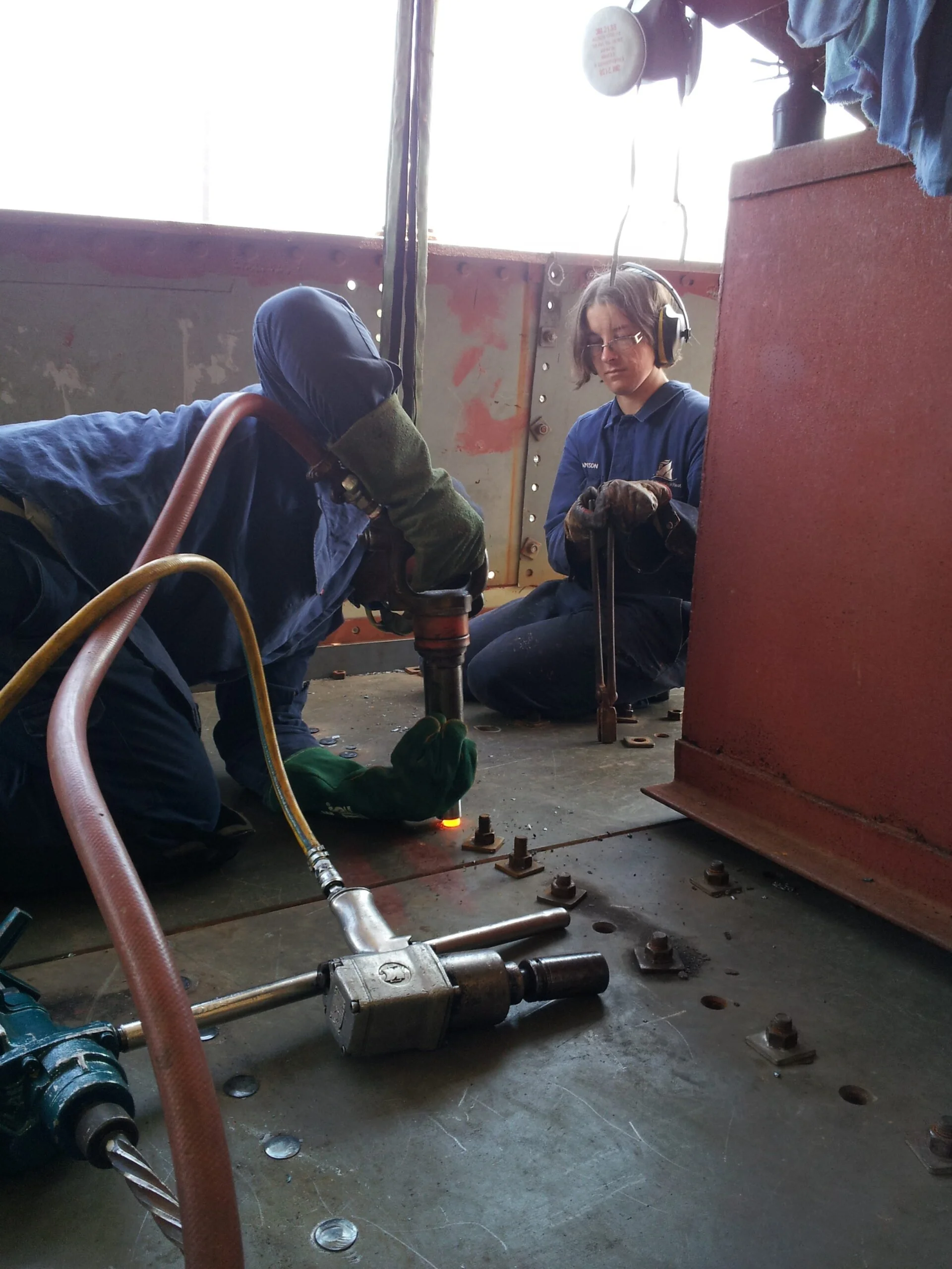 Hot riveting new steel plates main deck above engine room