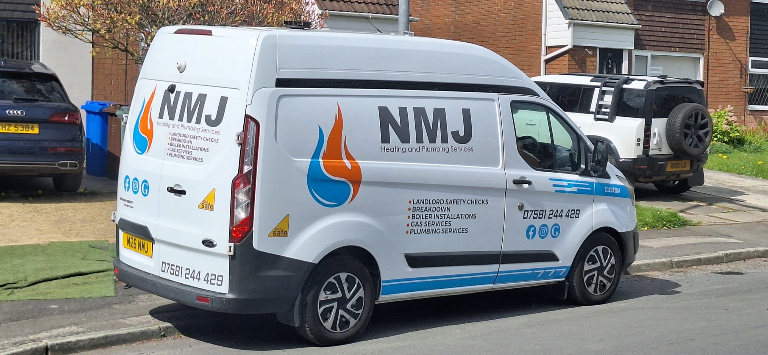 White NMJ heating and plumbing services van parked on a residential street, with a black car to the left and a black and white SUV behind. The van has colorful branding and contact information.