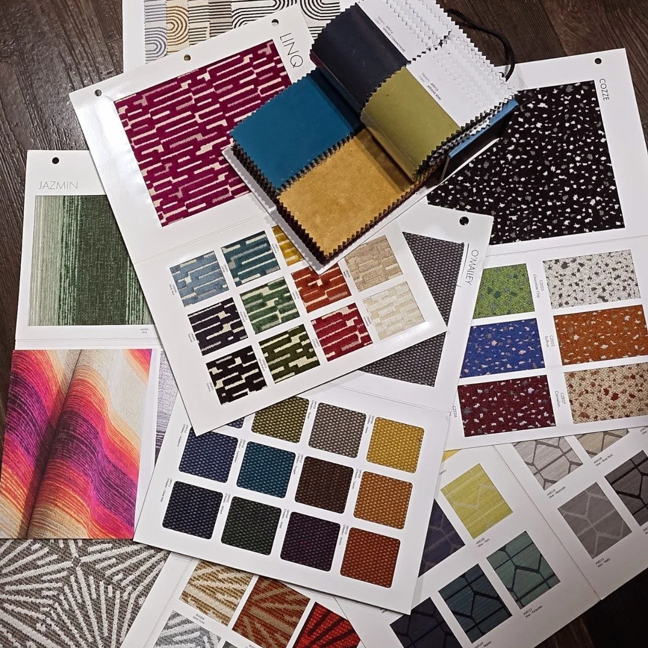 Upholstery fabric samples featuring a wide selection of colors, textures, and performance fabrics available for custom furniture upholstery in Dallas, Texas.