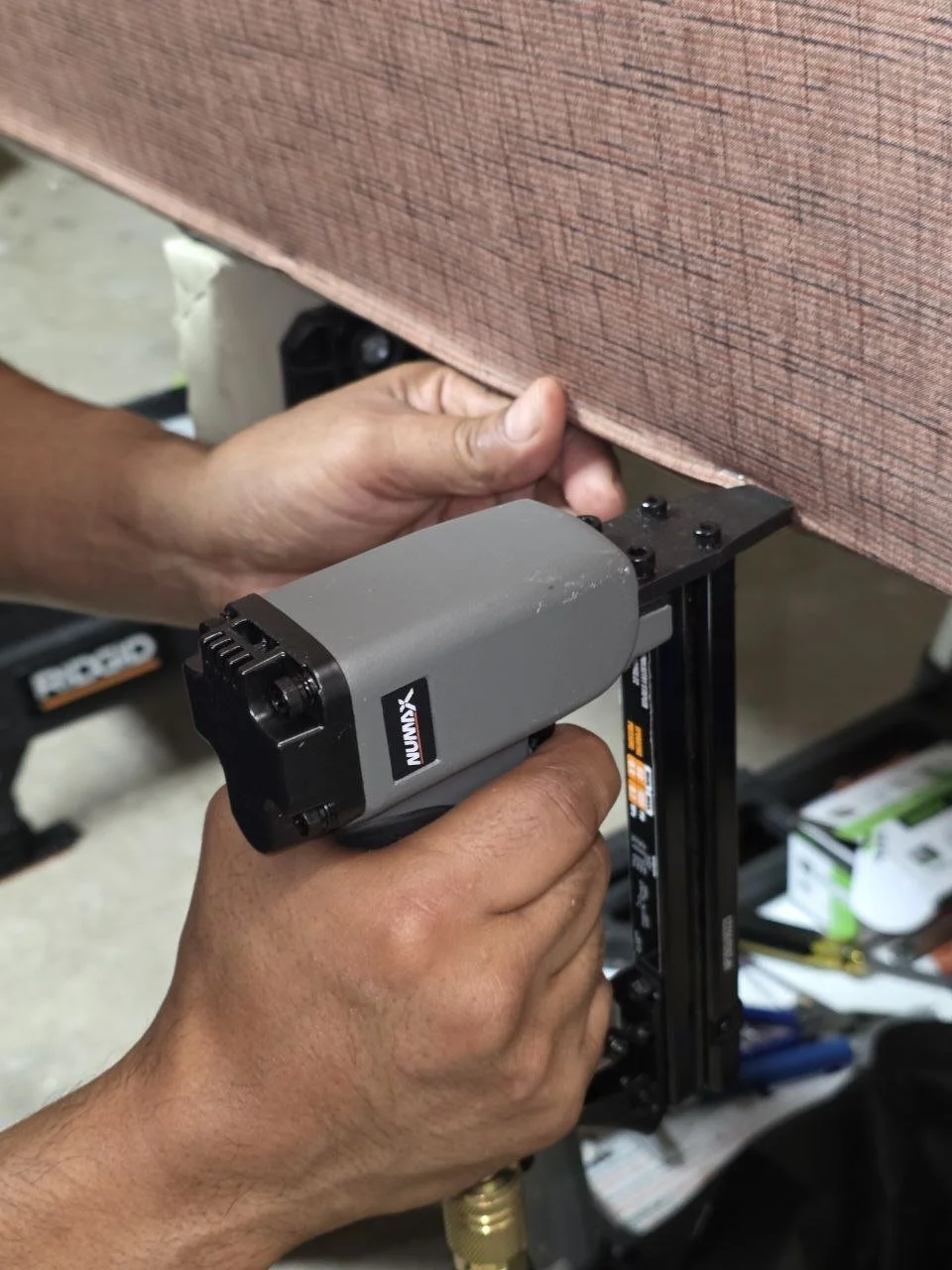 professional upholstery process securing fabric with staple gun Dallas custom furniture upholstery