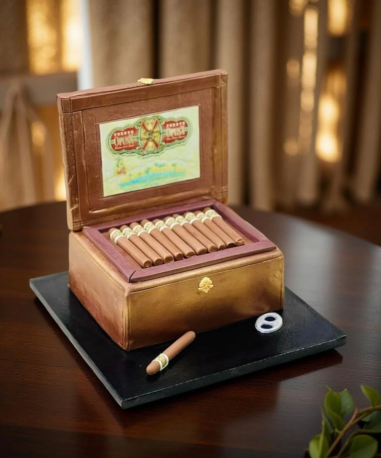 An open wooden cigar box containing several cigars, with one cigar partially outside the box on a black surface, and a small round object nearby on a dark wooden table.