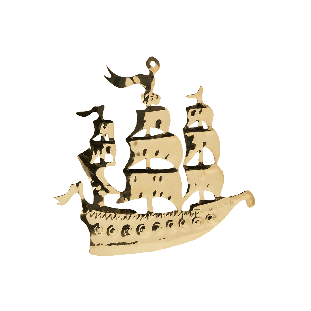 A decorative metal sculpture of a sailing ship with multiple sails and a bird perched on top, isolated on black background.