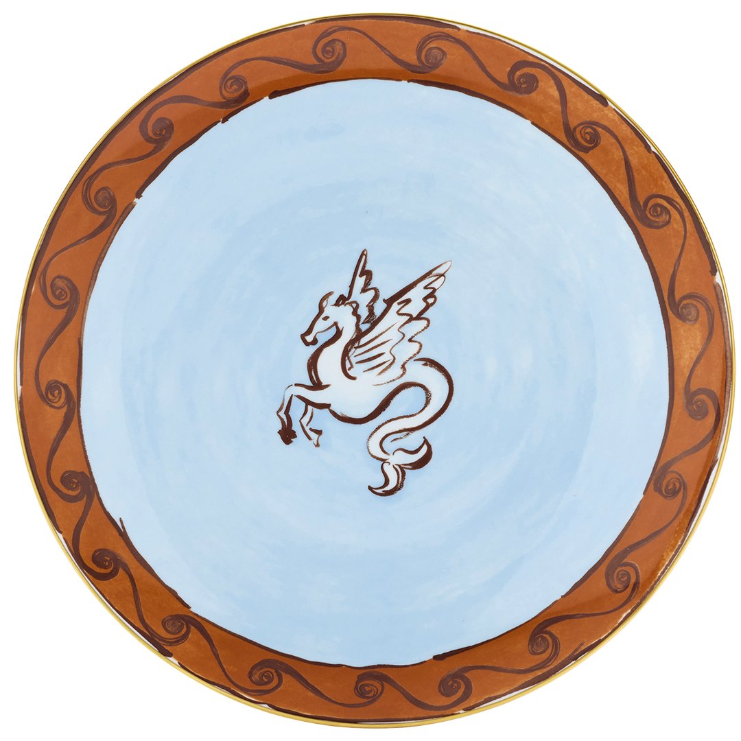 A round ceramic plate with a light blue interior and a brown decorative border featuring swirling patterns. In the center, there is a drawing of a mythical creature with a horse's body, unicorn horn, and dragon wings.