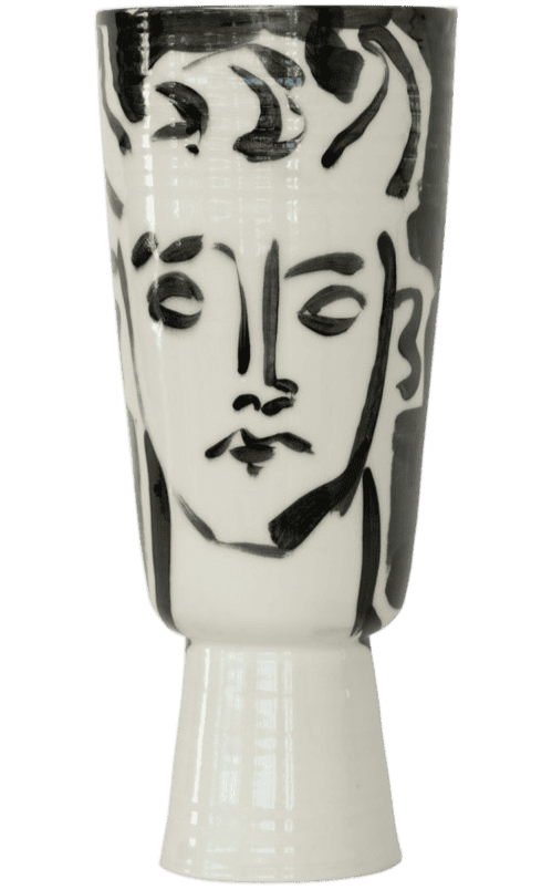 A ceramic vase decorated with a black and white abstract line drawing of a woman's face.