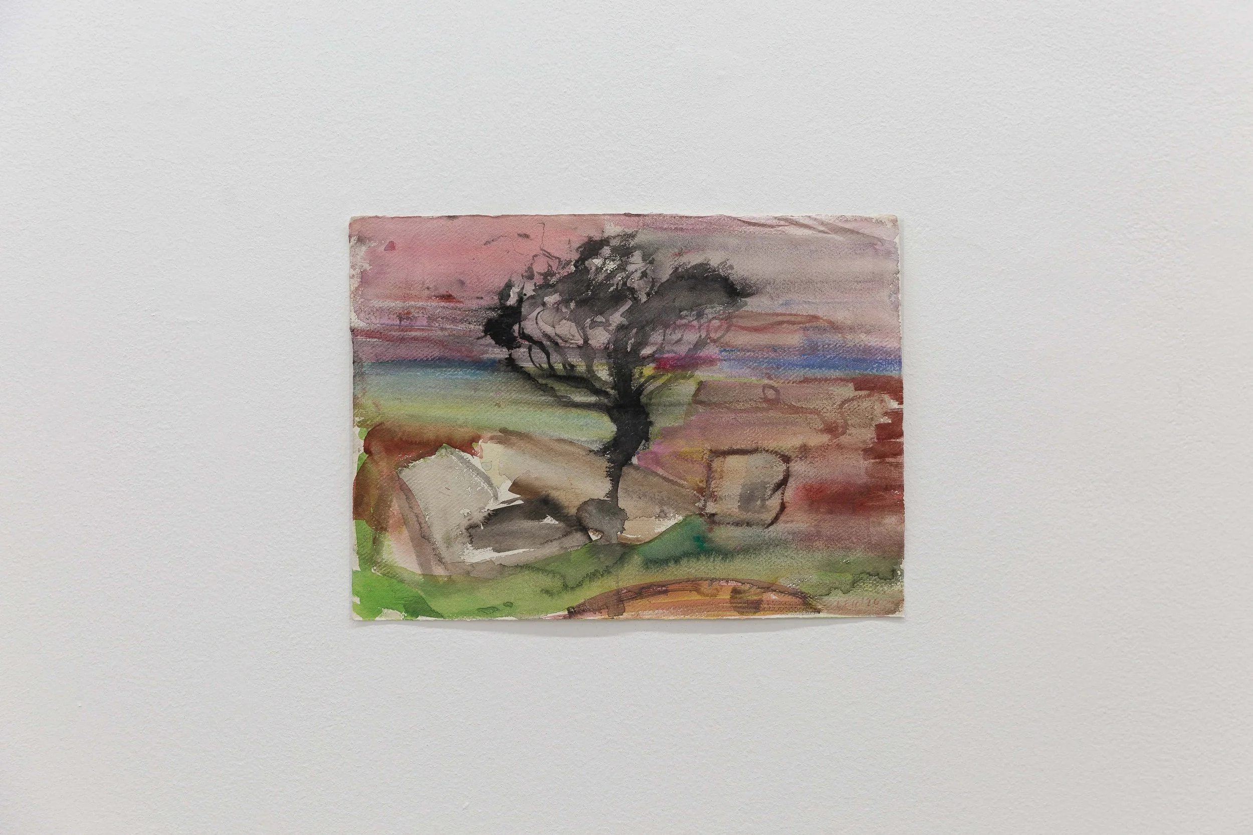 Small watercolor painting of a tree in a landscape with pink, purple, and green hues, mounted on a white wall.