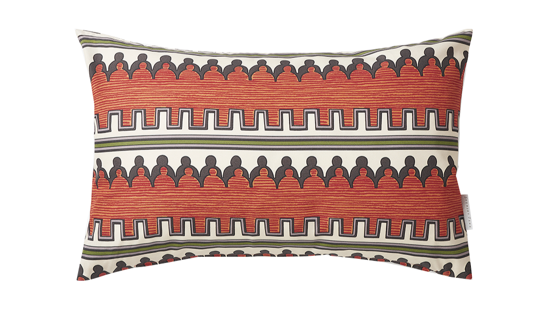 A decorative pillow with a colorful geometric pattern including black, red, white, and green shapes and lines.
