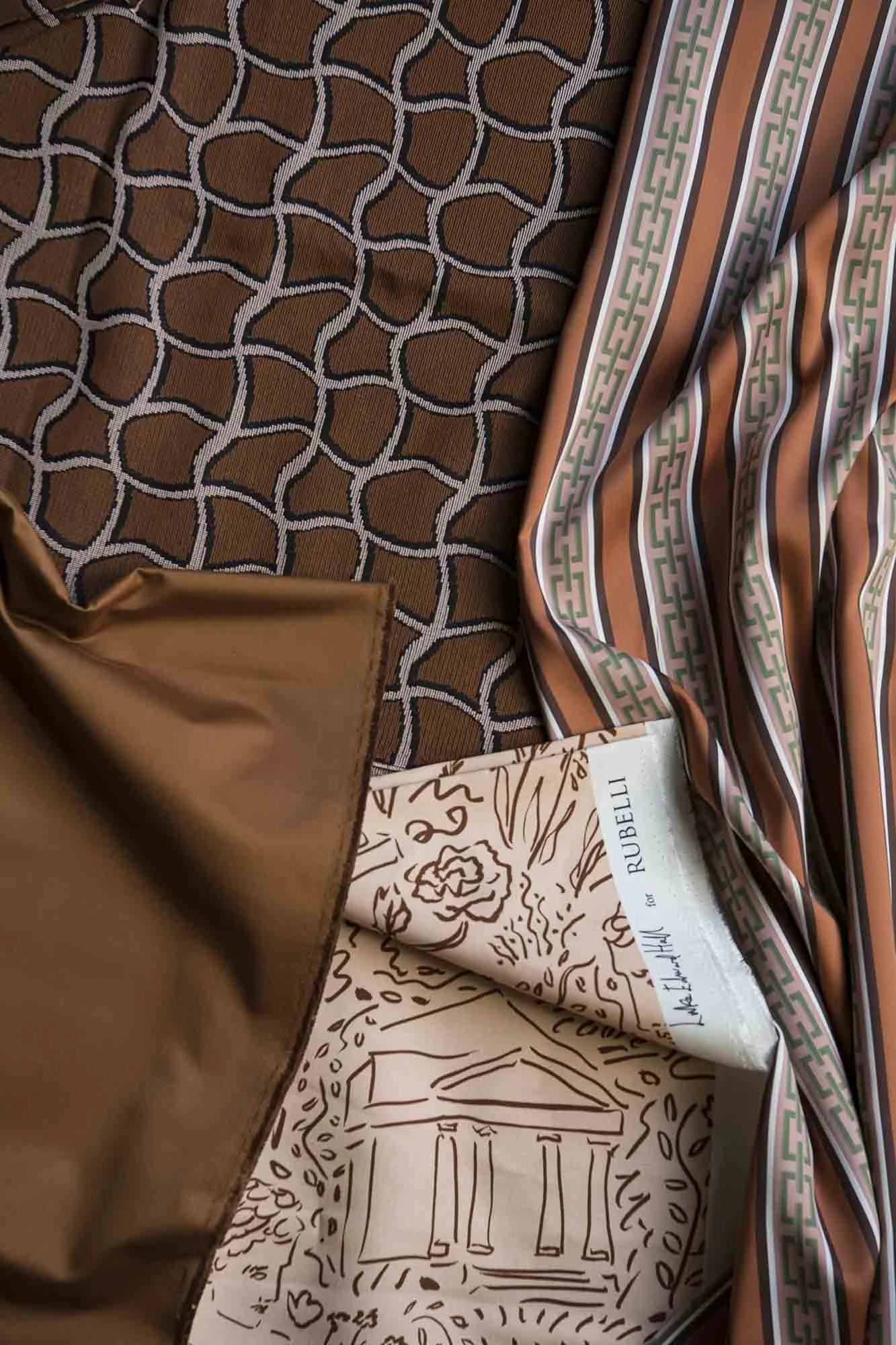 A collection of fabric swatches with various patterns and colors, including geometric, floral, and abstract designs.