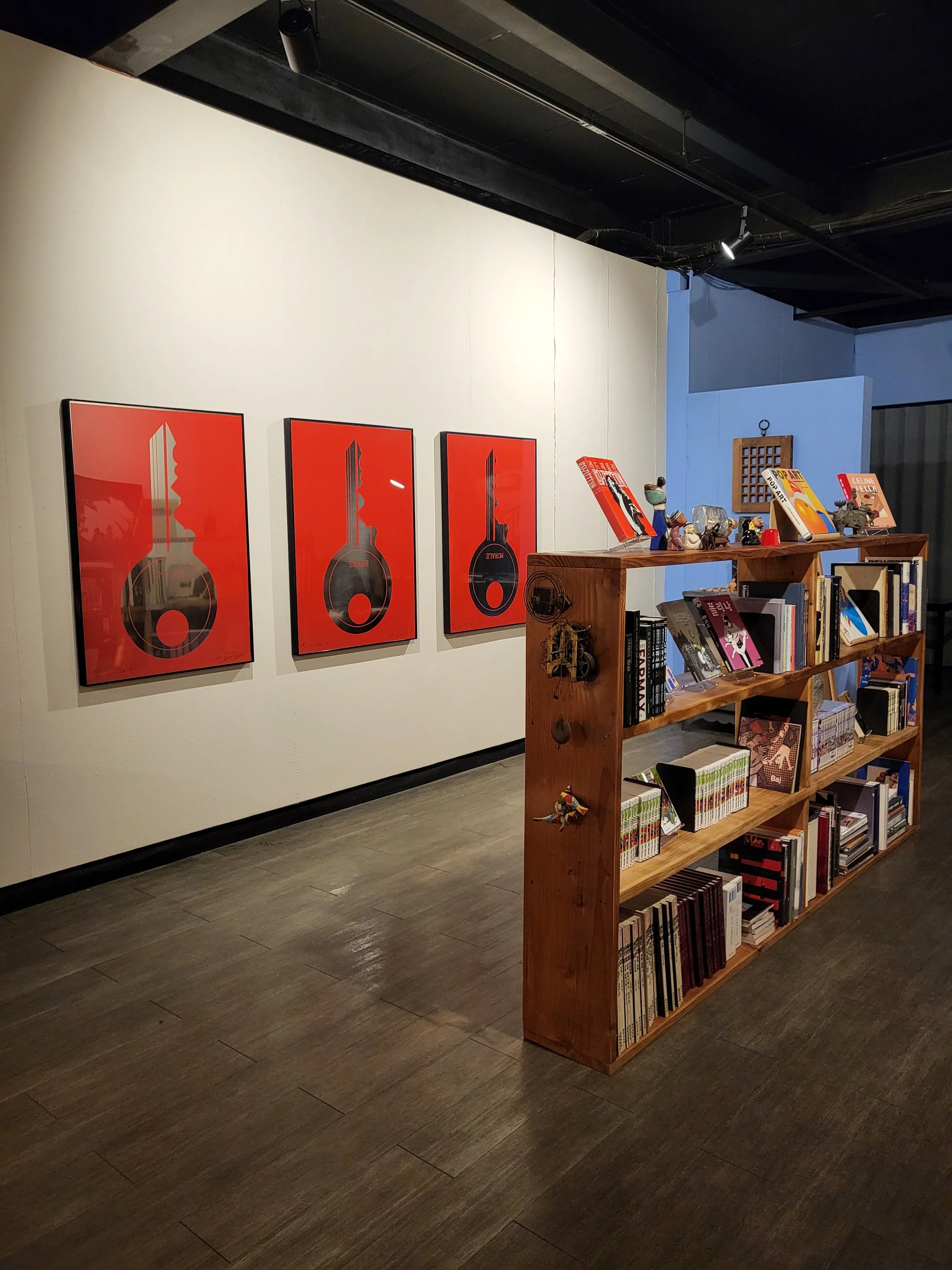 Archive and bookshop interior at Moon Art Grounds — Burnsoo Song exhibition venue with art books and framed works