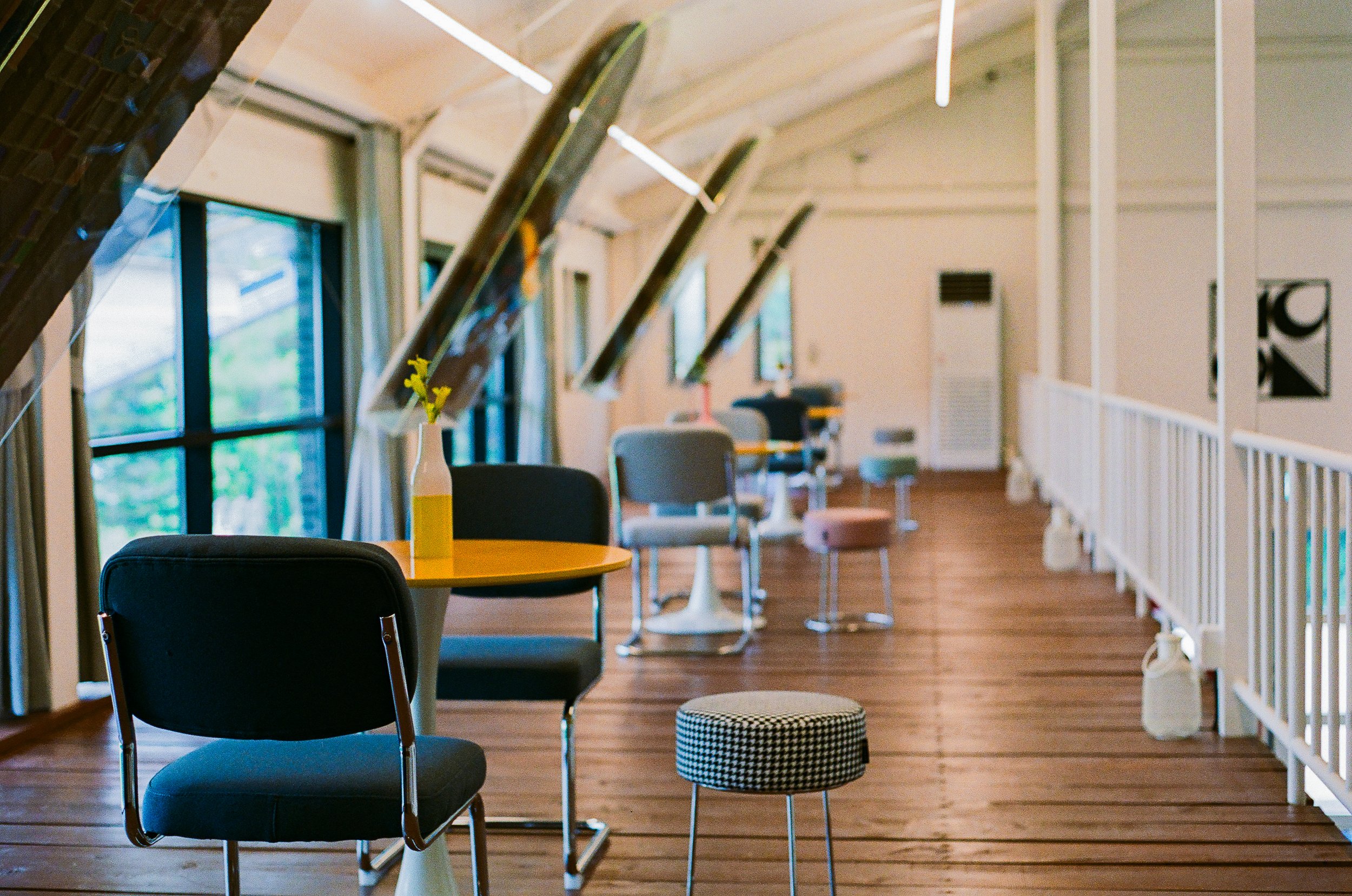 Reading room interior at museum venue exhibiting Burnsoo Song — sloped ceiling, large windows, cosy seating