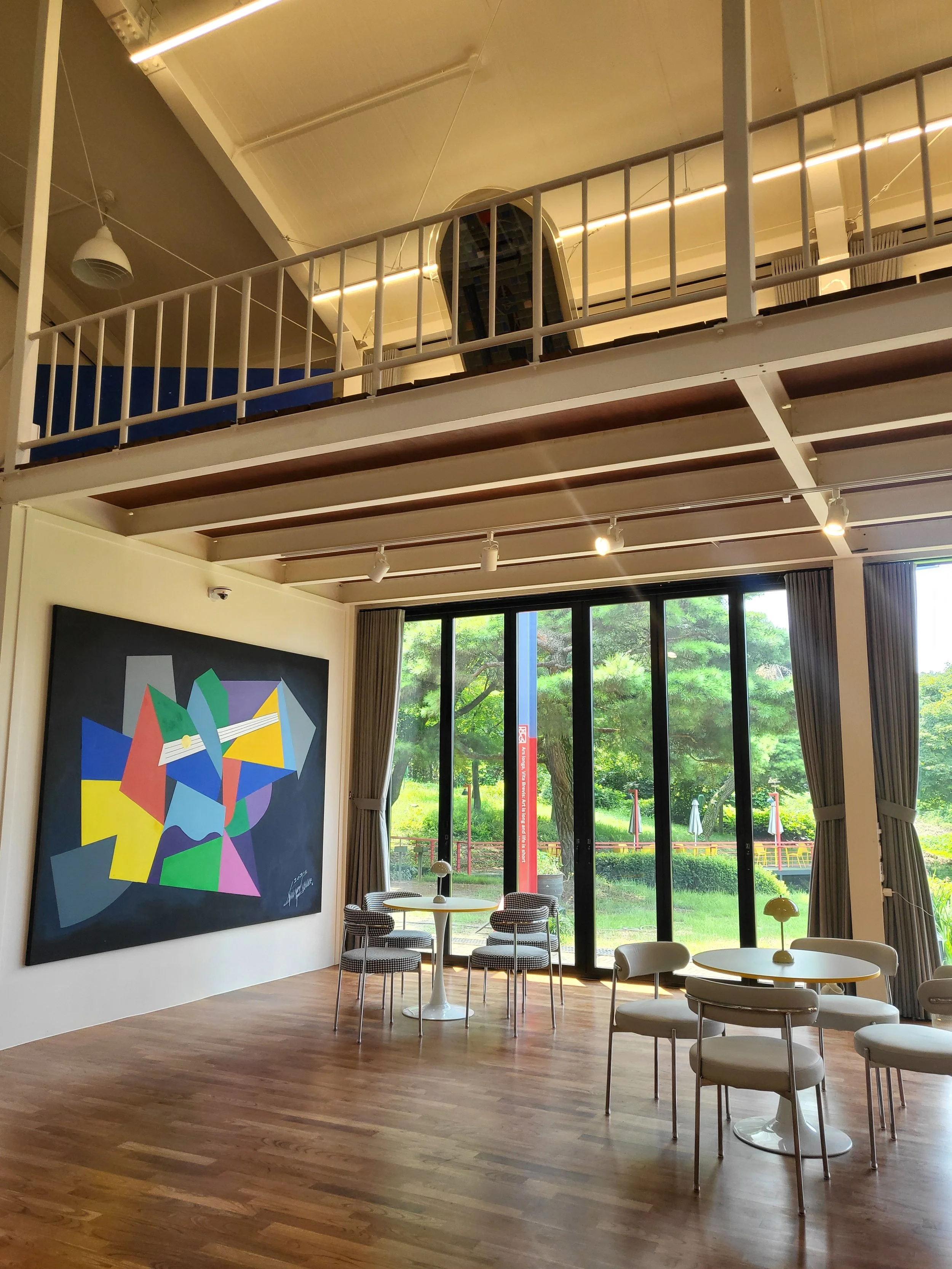 Main gallery room at Moon Art Grounds with large colourful abstract work — exhibition space for Burnsoo Song