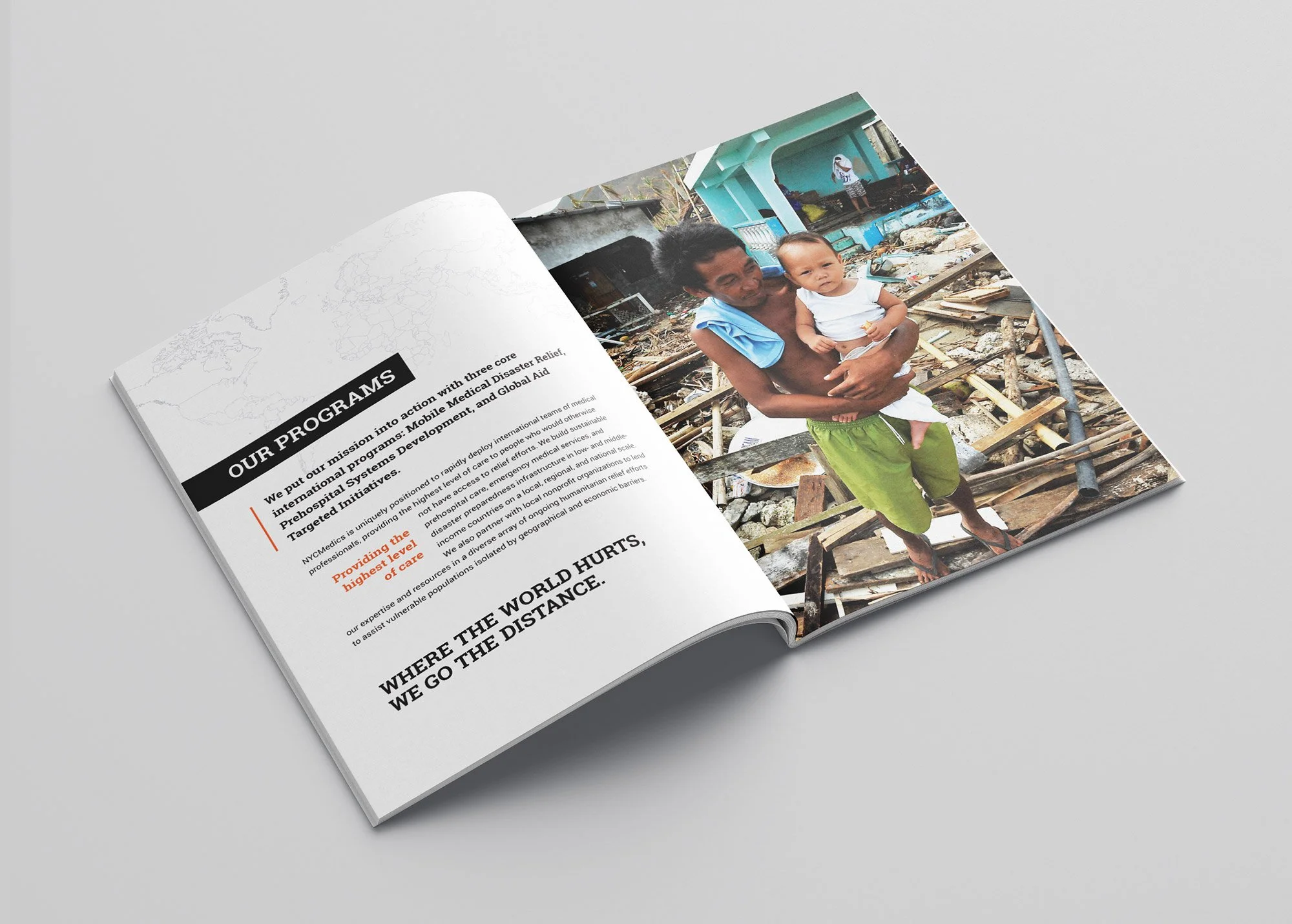 Open magazine showing a page with text and a photograph of an adult holding a young child in a scene of destruction and debris outside a building.