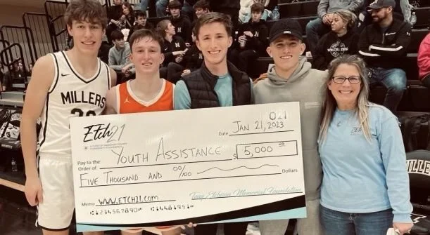 Recipients of a check from the Tony Etchison Memorial Foundation
