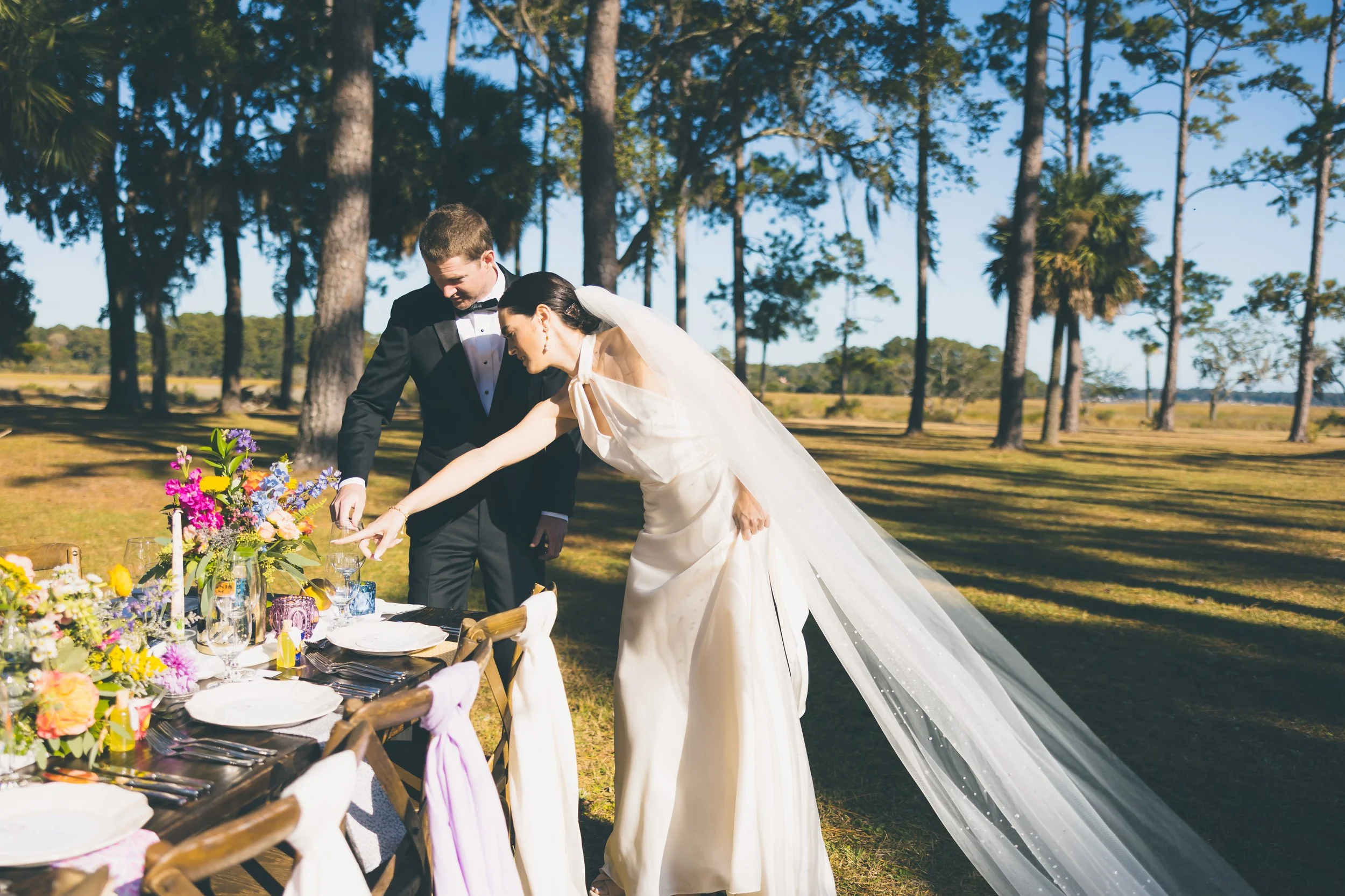couples wedding portrait looking at details