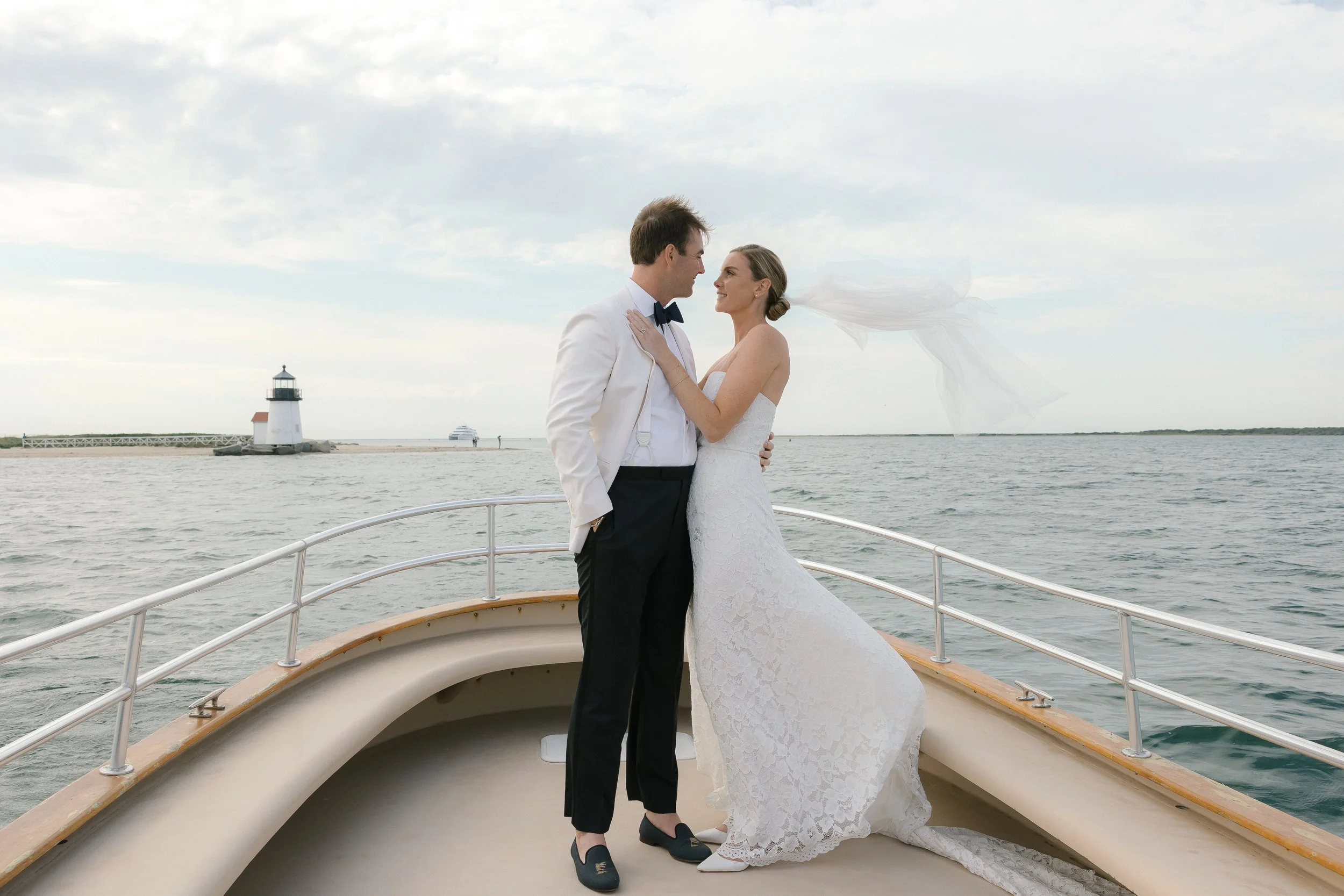 Wedding couple on boat in front of Brant Point Lighthouse