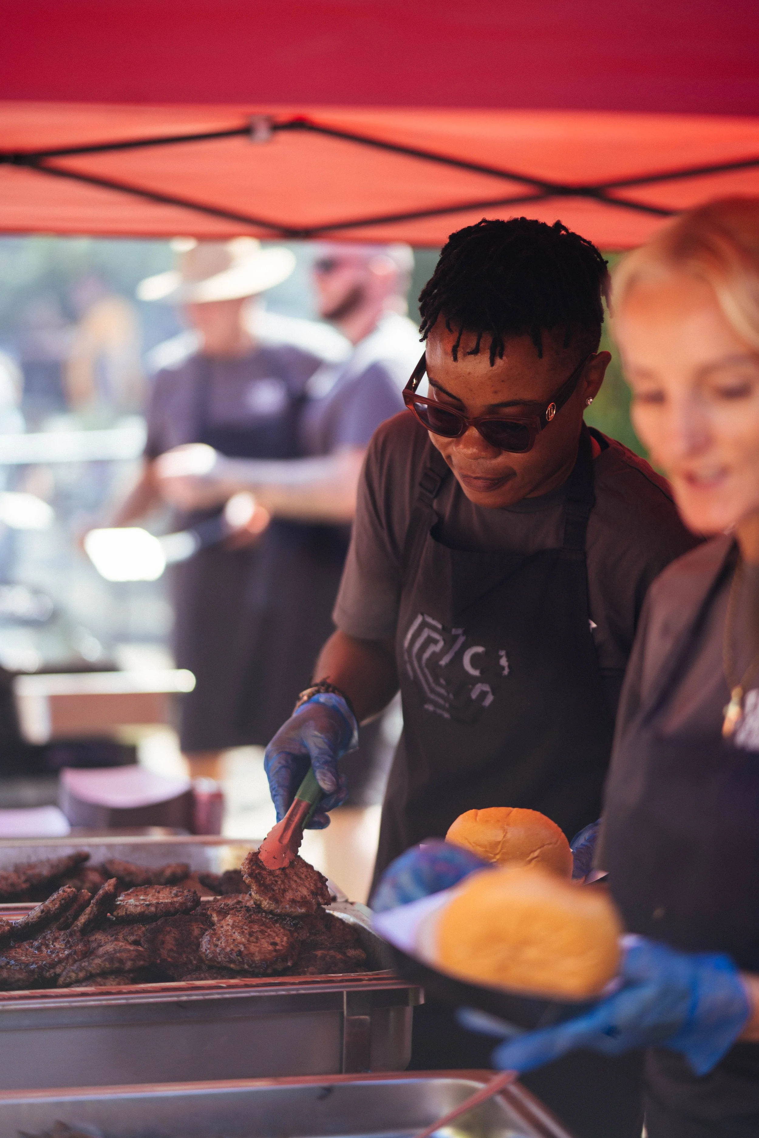 A black Lady, serving food for the community who need it