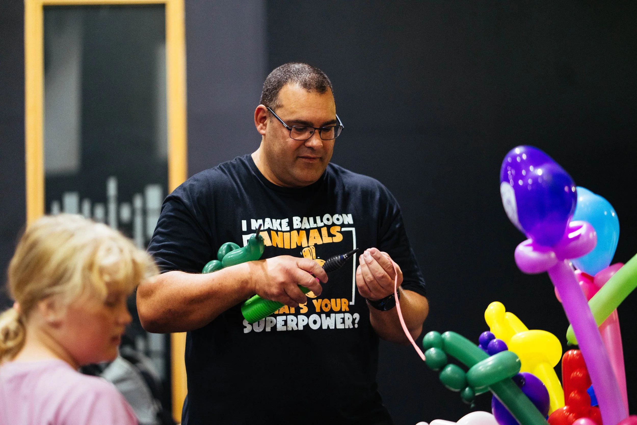 Man blowing up ballons to make