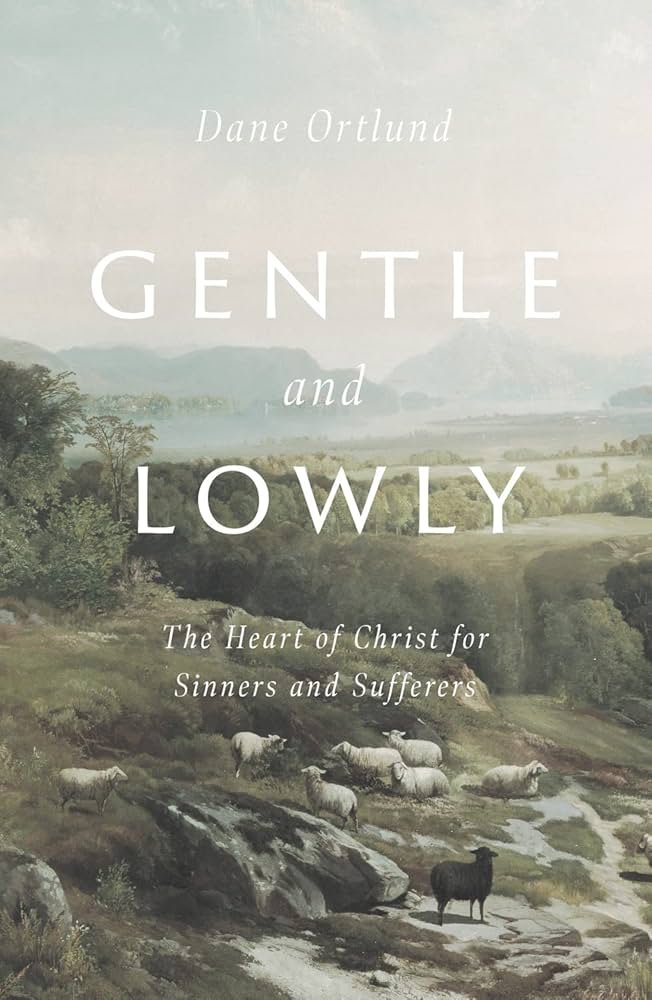 Book cover titled "Gentle and Lowly" by Dane Ortlund, featuring a pastoral landscape with sheep and a mountain range in the background.