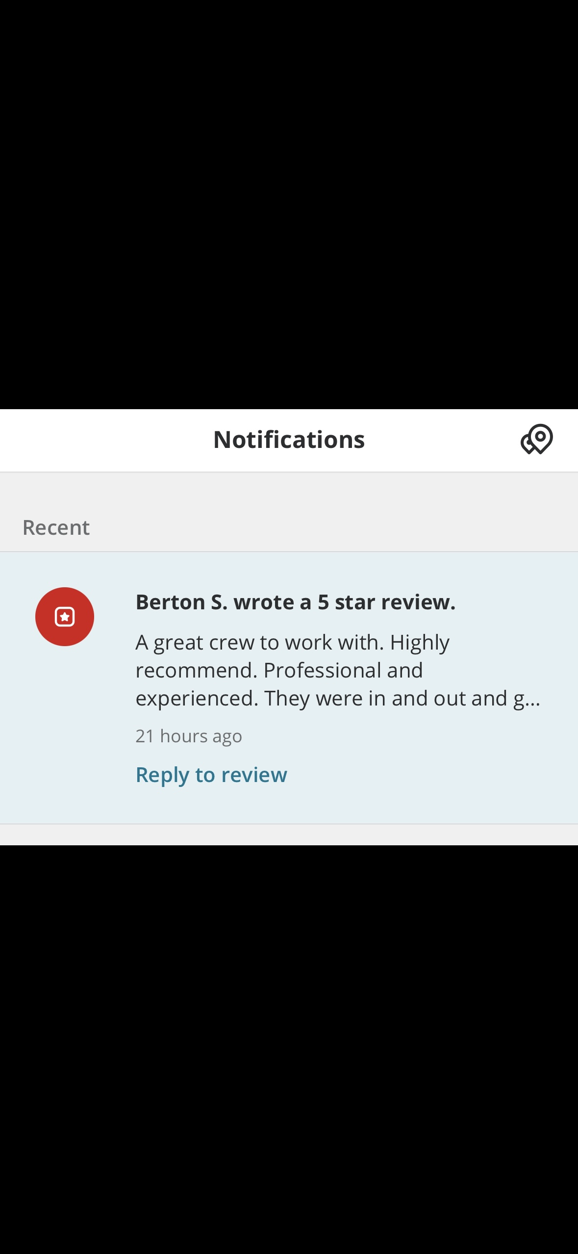 Mobile phone screen showing a notification from a review platform with a 5-star review by Berton S. praising the professional crew and their work, posted 21 hours ago.