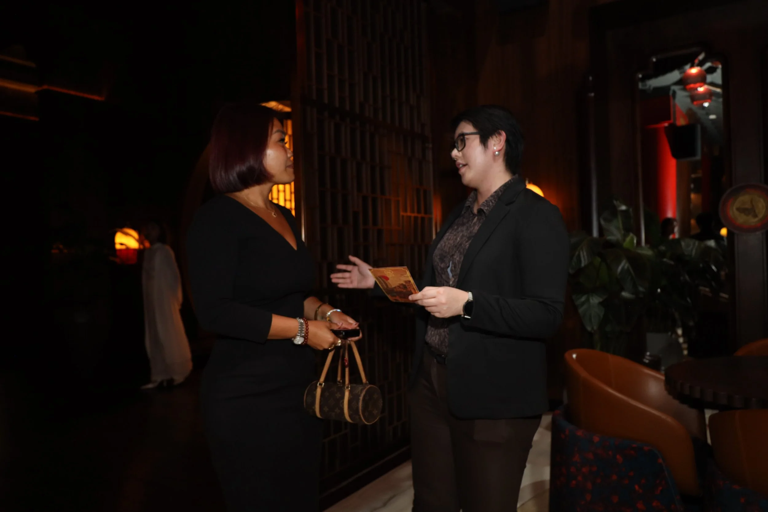 Two people at Reinv8nt events talking about relocating to Dubai