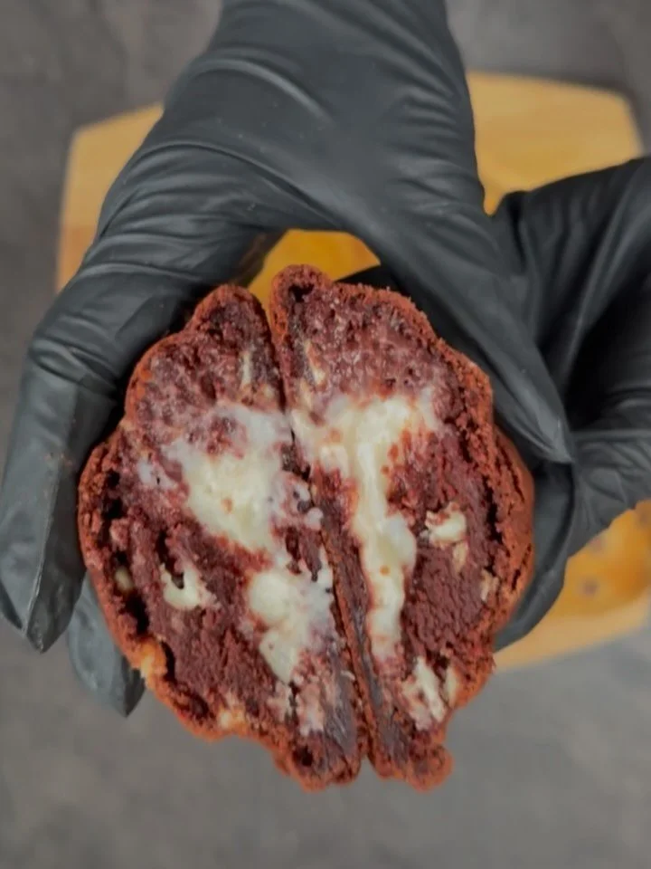 OUR SIGNATURE COOKIES🤎

First up is Red Velvet Dream!❤️
This yummy cookie is filled with white chocolate chips and stuffed with cream cheese , you may think mhmm cream cheese but guys this is a STUNNING cookie😍😍

Then we have our triple chocolate 