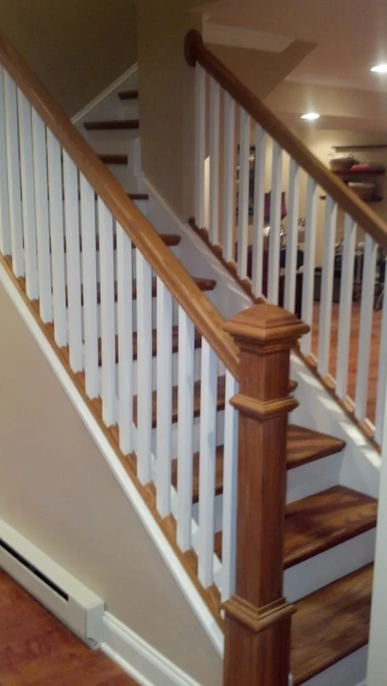 Wooden staircase with white and brown railings inside a home.