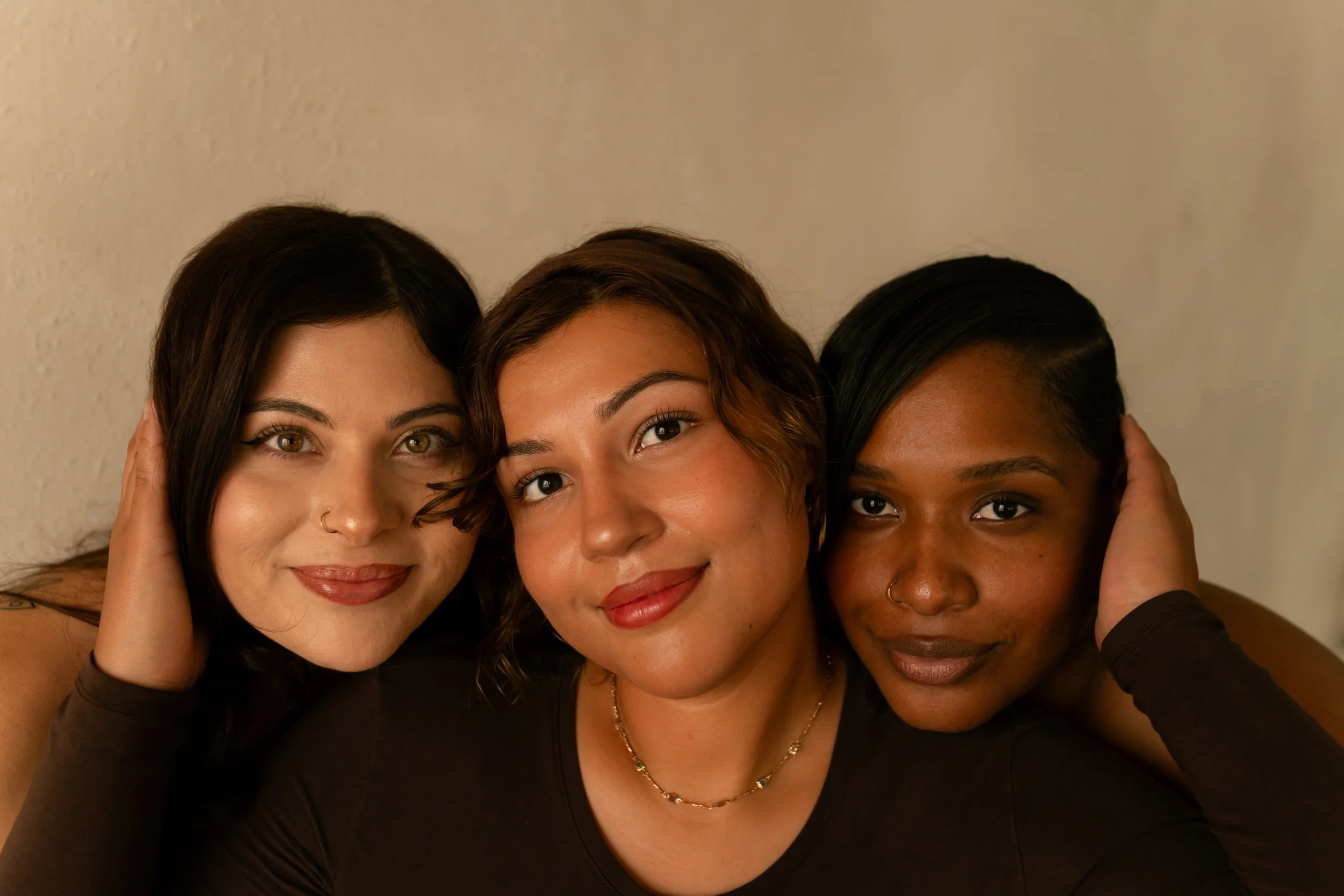 Two clients with glowing skin and natural beauty results, showing smooth complexions, softly groomed brows, lifted lashes and a confident studio experience.