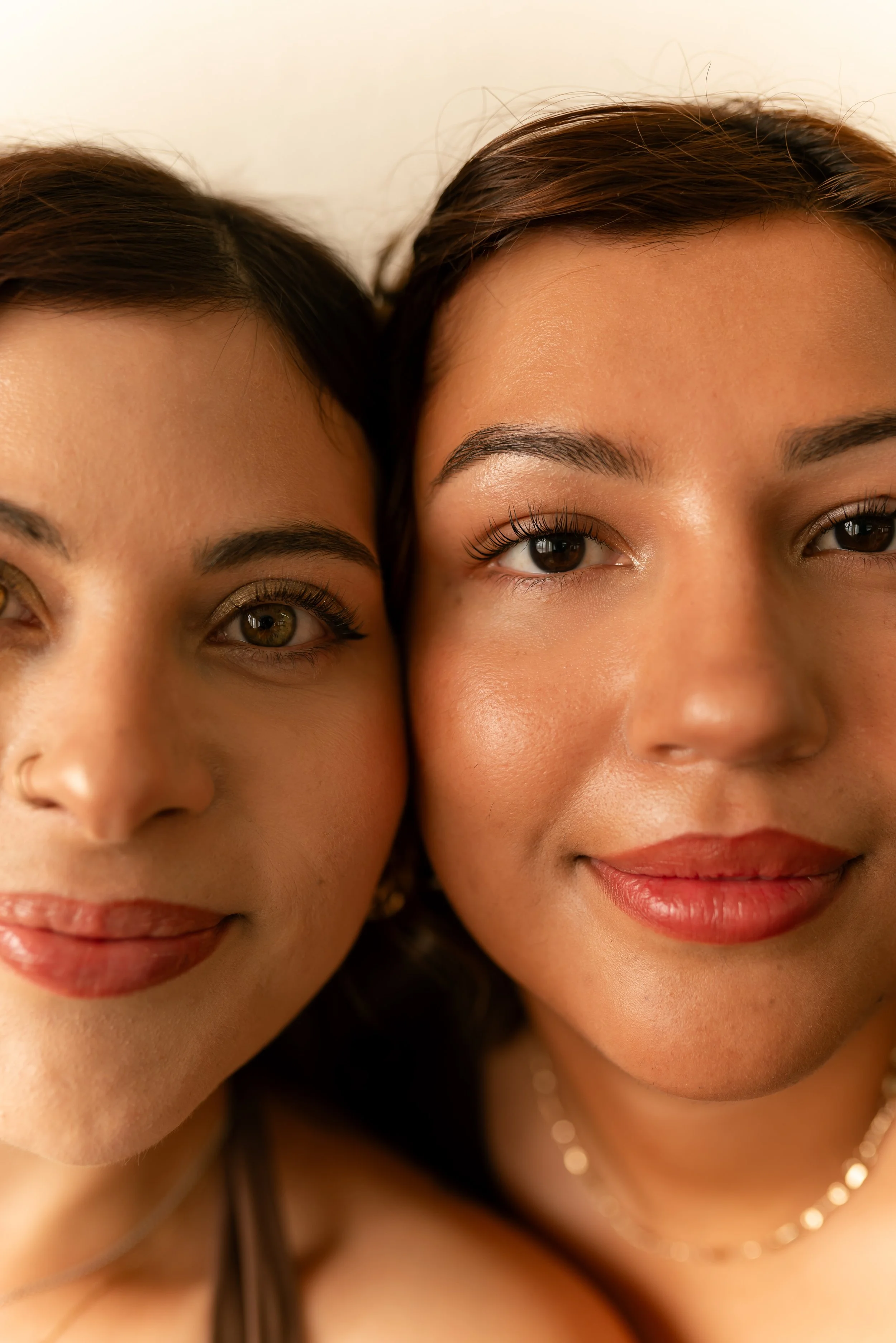 Two clients with glowing skin and defined lashes, highlighting natural beauty results from professional esthetician services.