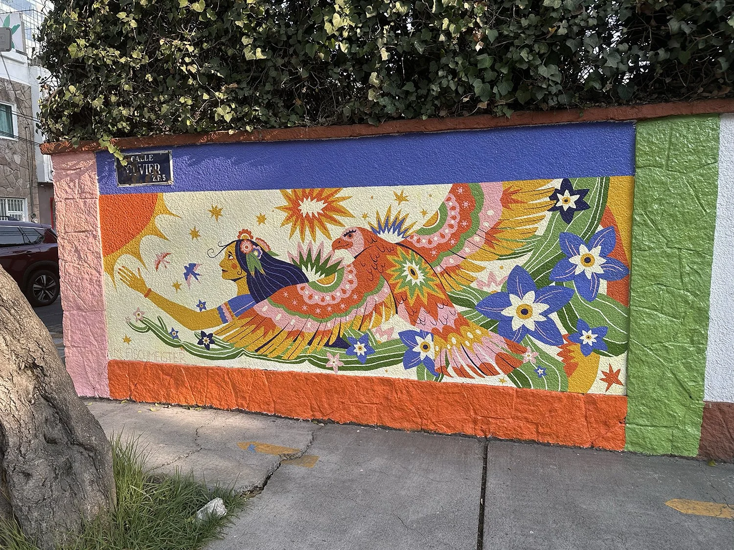 mexican mural with a mexican eagle with folklore patterns and a woman in a flower crown surrounded by cactus