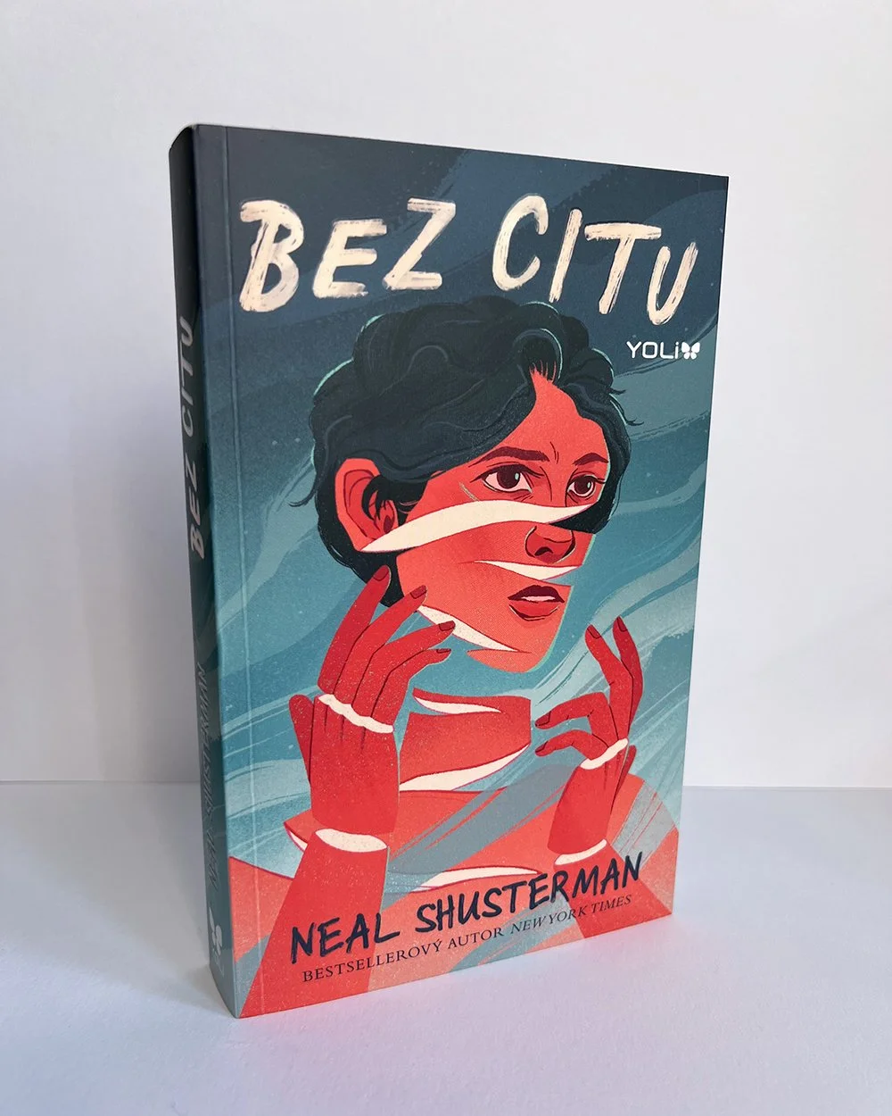 book cover of neal shusterman bez citu, featuring a boy with a sliced fragmented face