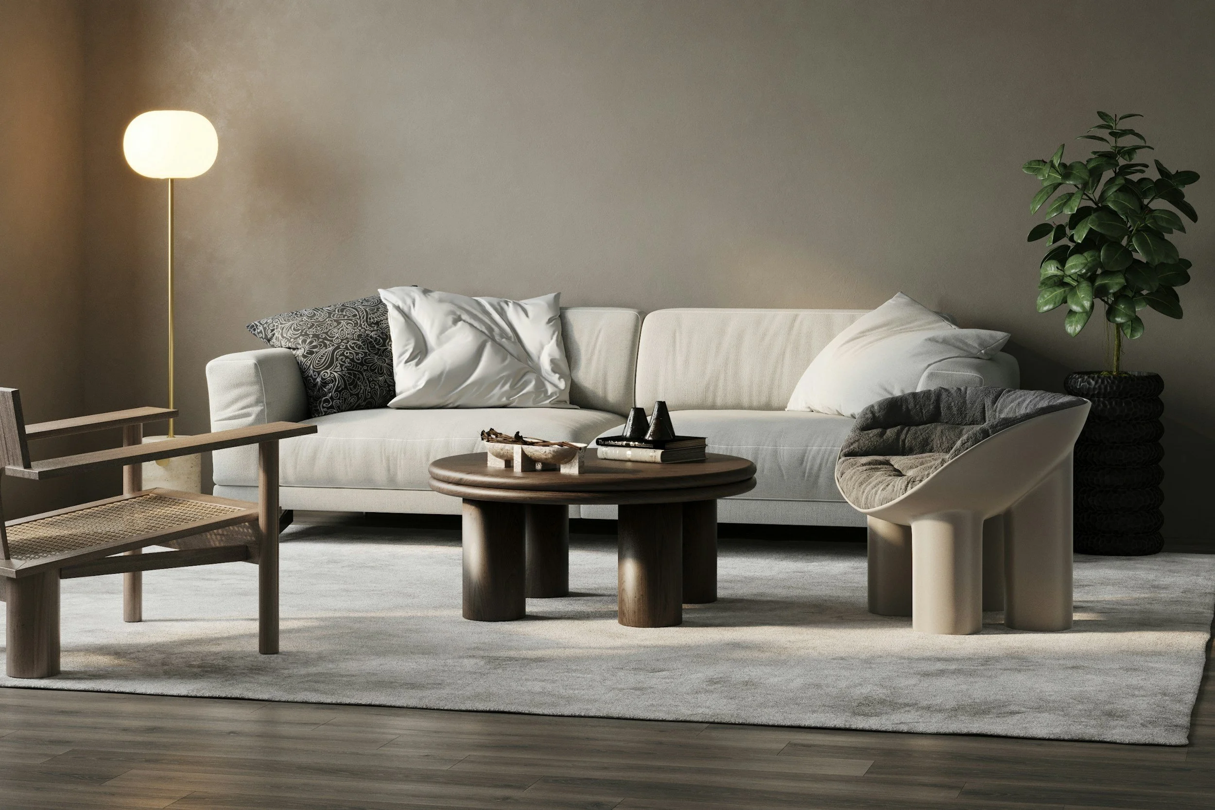 Living room with a beige sofa, black and white pillows, a wooden coffee table with books and decorative objects, a white modern chair, a side table, a tall green potted plant, and a tall floor lamp, all on a beige carpet with dark wooden flooring.