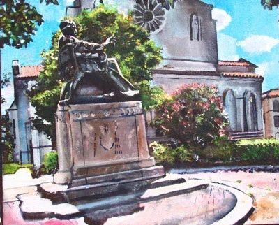 A bronze statue of a man sitting on a pedestal with greenery and a church in the background.