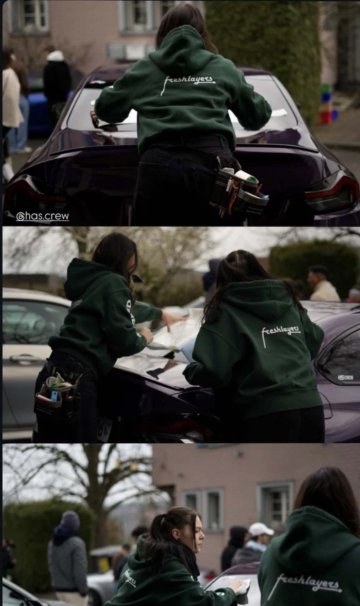 People gathered outdoors, some in green hoodies, participating in an event or activity involving paperwork on a car's hood and instances of social interaction, with trees and buildings in the background.