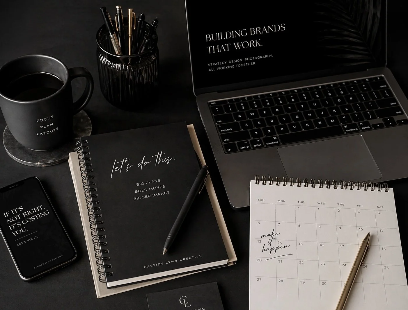Modern branding workspace with laptop, coffee, phone, and planner styled for business website design and brand strategy services