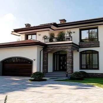 Front view of a modern two-story house with a curved driveway, large windows, and a balcony with potted plants.