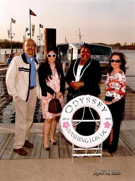 Four people standing on a dock near a boat, with flags and a life preserver marked 'Odysey WASHINGTON DC 2013'. It is April 16, 2013.