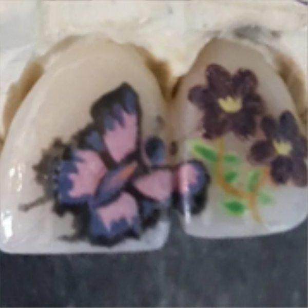 Two pieces of soap with painted butterfly and flower designs.