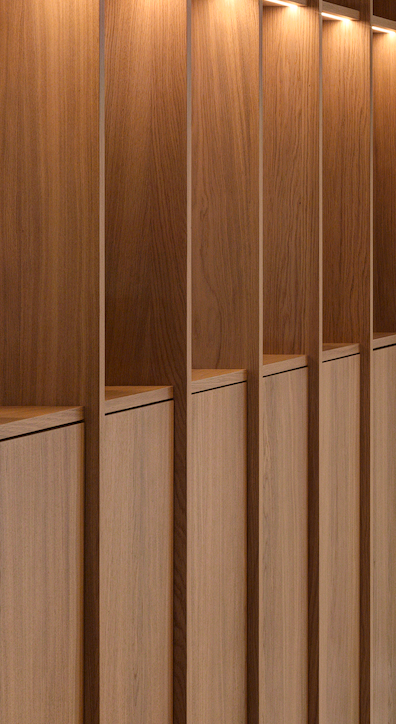 Wooden lockers with vertical dividers, some with open spaces at the top, and overhead lighting illuminating the lockers.