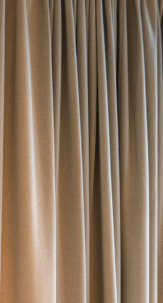 Beige curtains hanging closed.